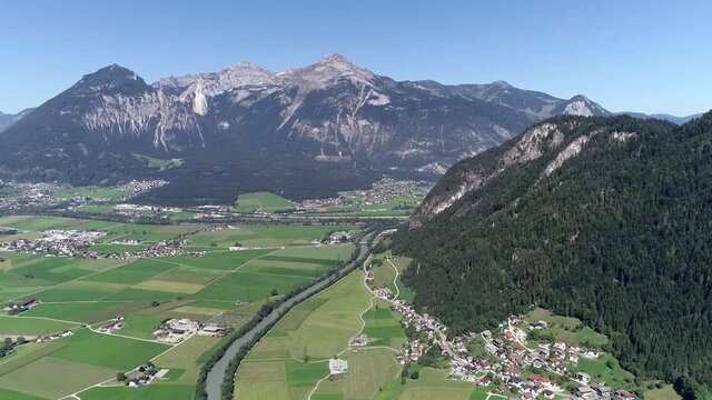 Aerial view of Bruck-am-Ziller is a municipality in the Schwaz district in the Austrian state of Tyrol the name derives from the river Ziller in background showing alp mountain range 4k quality