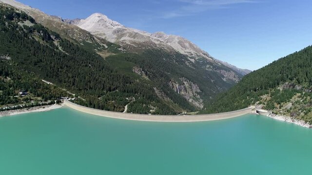 Aerial view of Austria Schlegeis Stausee showing the Alps in the background the structure is a barrier that stops the flow of surface water and is used as hydropower to generate electricity 4k quality
