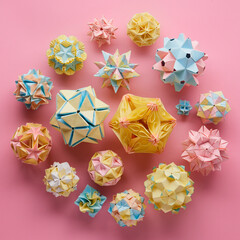Set of multicolor handmade modular origami balls or Kusudama Isolated on pink background. Visual...