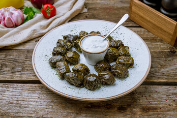 Dolma georgian kitchen with sour cream on old wooden table