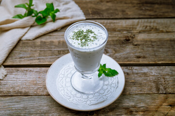 ayran in a glass on old wooden table - 446682755
