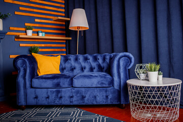 The interior of the room is in blue color. Blue sofa. Coffee table.