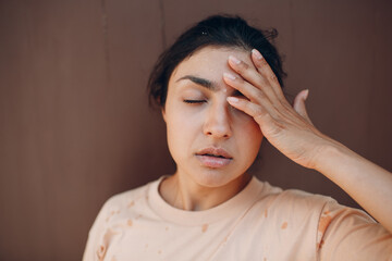 Stressed woman with sweat drops on her face suffering of heatstroke refreshing with cold water...