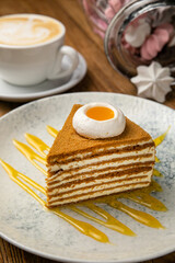 Honey cake in a plate on a wooden table