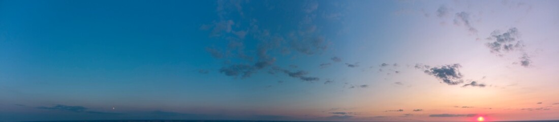 Panorama of the sunset. Orange and blue sky.