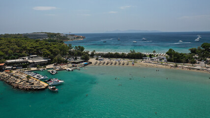 Fototapeta na wymiar Aerial drone photo of famous celebrity sandy beach of Astir or Asteras in south Athens riviera with turquoise clear waters, Vouliagmeni, Greece
