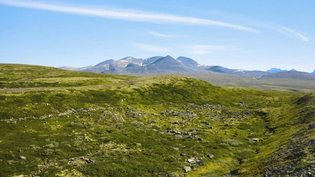 Rocks On Grassy Hill Of Rondane National Park With Mountain Views In Norway. - aerial