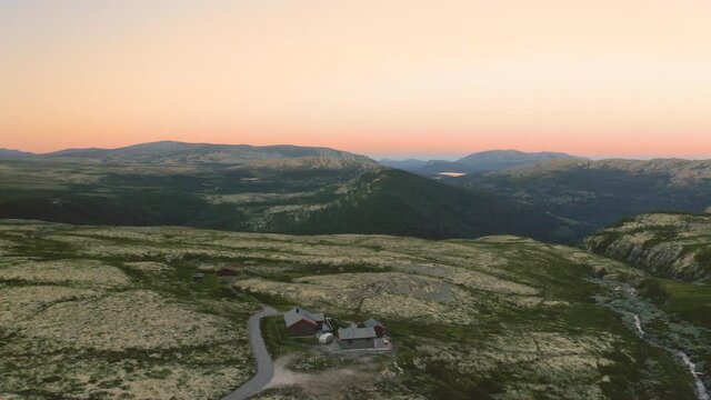 Cabin House At The Rugged Landscape Within Rondane National Park At Dusk. aerial