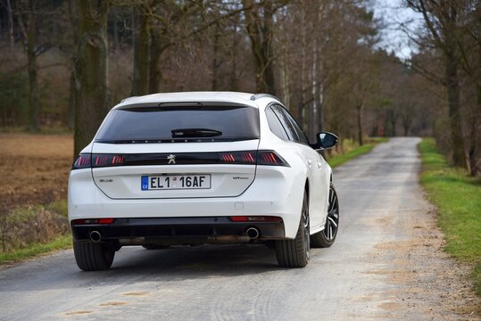 Peugeot 508 SW PHEV. Plug-in hybrid car on a country road. The back of the car. 04-11-2021, Middle Bohemia, Czech Republic.