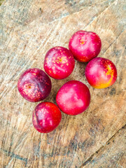 Red plum on tree stump.