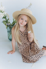 Cute joyful little girl portrait. Blondie adorable baby girl in hat on white background