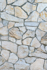 stone wall made of sandstone blocks of different sizes as the background