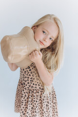 Cute joyful little girl portrait. Blondie adorable baby girl in hat on white background