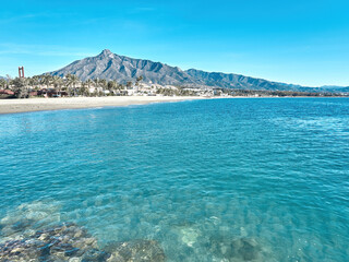 Marbella beach with blue sky and the shell behind. La Concha is the most famous mountain in Marbella