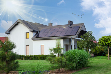 Beautiful house with solar panels. Clear sky an sun. ECO CONCEPT.