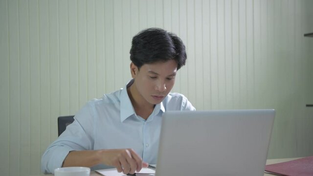 Business concept of 4k Resolution. Young Asian men are tired of working in the office.