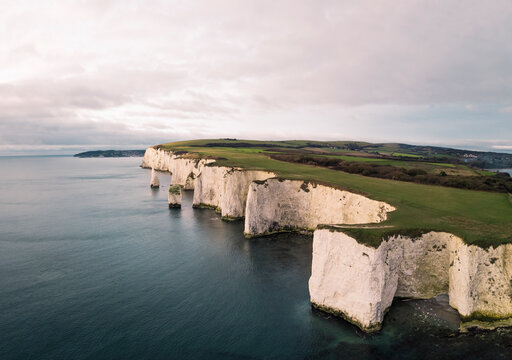 Aerial view of Old Harry Rocks, a chalk formations at sunrise, Ballard Down, Studland, Dorset, United Kingdom.