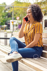Young adult woman having a call and laughing