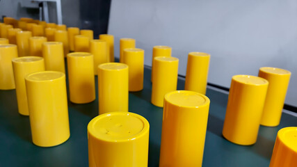 Yellow Plastic product bottle parts. made from plastic injection molding machine, in plastic factory industry.