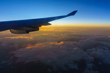 Fototapeta premium Beautiful sunrise with aircraft wing during View from windows aircraft