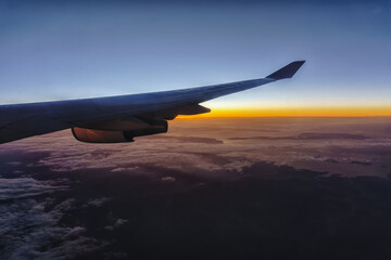 Fototapeta na wymiar Beautiful sunrise with aircraft wing during View from windows aircraft