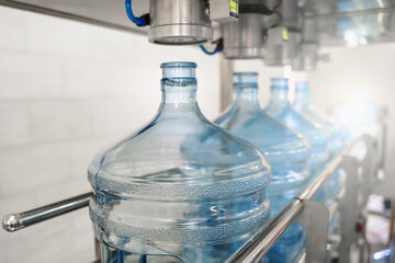 Process of production manufacturing purified drinking water and packaging in plastic bottles in beverage factory, food industry, conveyor belt.