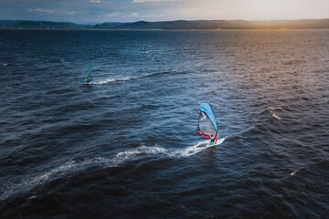 Vladivostok, Russia - 12 July 2020: Aerial view of group of windsurfers surfing near Vladivostok, Russia.