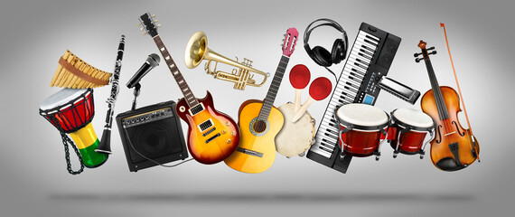 wide panorama collage  of various musical instruments. Guitar keyboard Brass percussion studio music concept grey background - obrazy, fototapety, plakaty