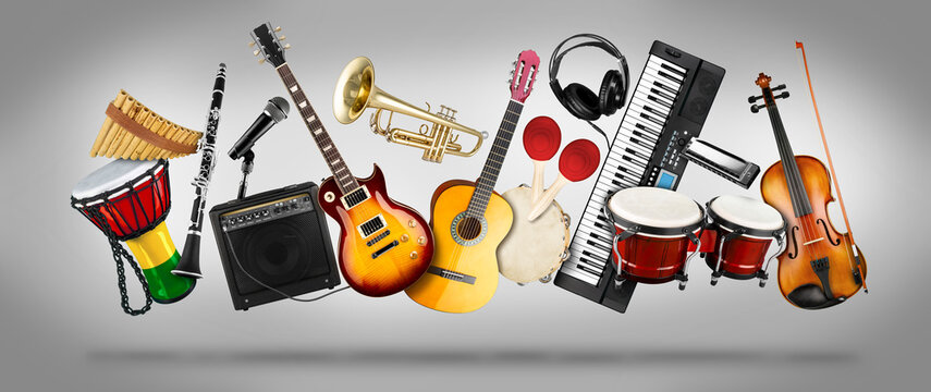 wide panorama collage  of various musical instruments. Guitar keyboard Brass percussion studio music concept grey background