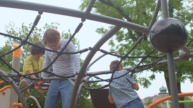 Pre-teens play on a playground with ropes during their school break. Kids with special needs recreation. Outdoor play has a fundamental role in a child's early development. 