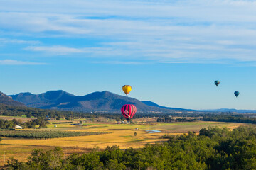 Hot air balloons rising from the ground at the Hunter Valley, Australia