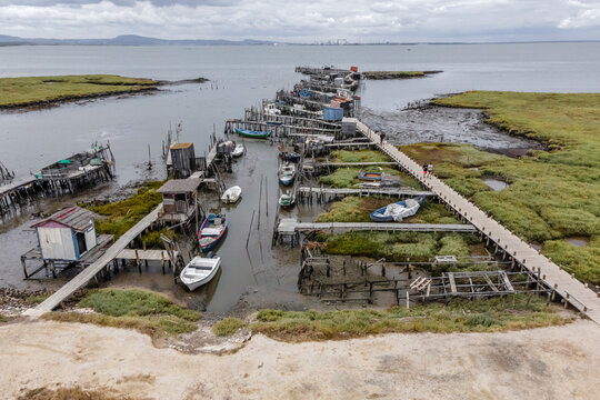 Aerial view of Porto Palafita da Carrasqueira, a beautiful pier made of wood by fishermen renowned for its sunset view, Comporta, Troia Peninsula, Setubal, Portugal.