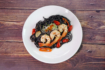 Squid ink spaghetti with prawn. Italian  food. Selective focus, top view