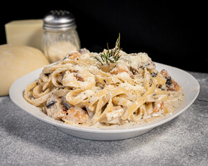 Delicious chicken parmesan pasta, served on a white plate.