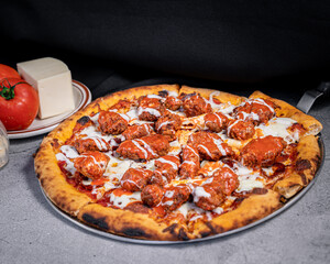 Exquisite boneless pizza with buffalo and cheese.
