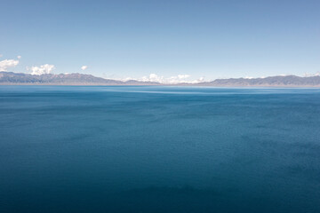 Lake and grassland with a sunny day. Shot in Sayram Lake in Xinjiang, China.