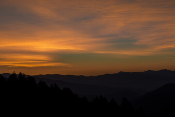 Warm orange Sunrises over silhouetted forest and mountain tops at New Foundland Gap in the Great Smoky Mountains