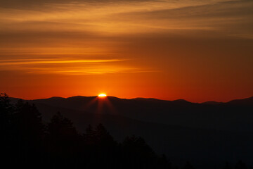 Warm orange Sunrises over silhouetted forest and mountain tops at New Foundland Gap in the Great Smoky Mountains