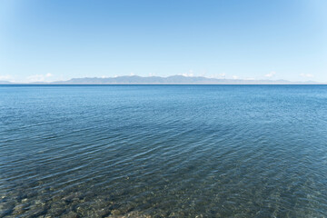 Calm surface of the lake with a sunny day. Shot in Sayram Lake in Xinjiang, China.