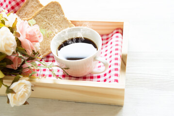 Cup of coffee and flowers and good morning. Lifestyle Concept.