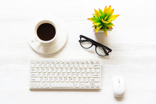 smartphone, tablet and coffee cup with financial documents on wooden table. Office stuff. Bussines coffee break concept.