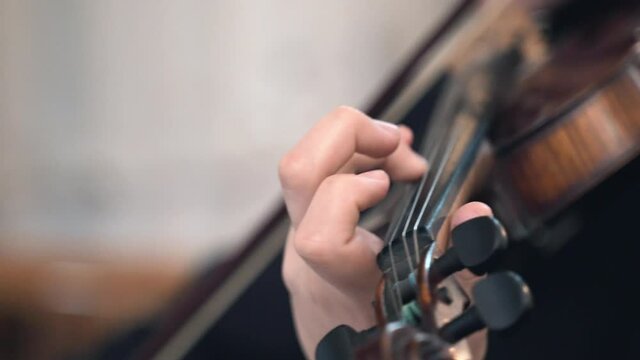 Musical performance in church during religious mass, talented nun playing the violin in symphony with religious choir. Nun holding musical prayer glorifying God, concept of religion and the arts