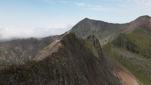 Close Up Of Knife-edged Narrow Ridge Crib Goch And Snowdonia Mountain Range In Snowdonia National Park, Gwynedd, Wales (UK). aerial orbit
