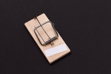 Blank White Sheet of Paper in Wooden Mousetrap - Template. Small Memo Paper in Mouse Trap on Black...