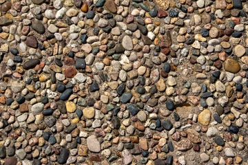 Foto op Canvas Top view close-up texture background of a vintage exposed aggregate stone patio surface in bright natural sunlight  © Cynthia