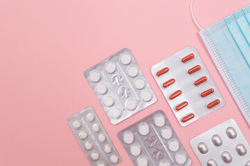 Different Pills and Tablets Package on Pink Background. Top View, Flat Lay