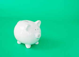 finance saving money, withe isolate  piggy bank on green background 