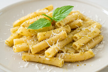 pesto rigatoni pasta with parmesan cheese