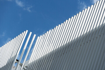 contemporary white grey metal architecture on blue sky background.