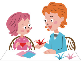 大人の女性と女の子が折り紙で鶴を織っています。